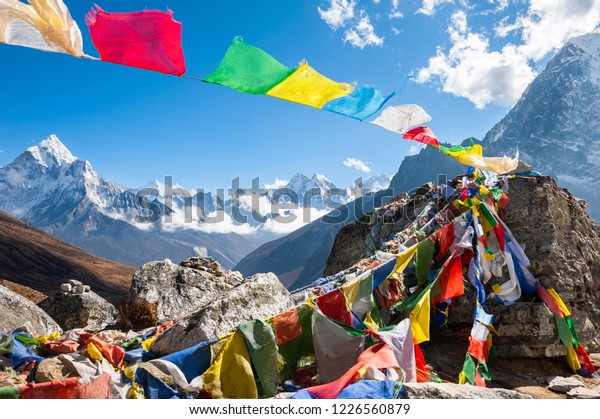 Colorful\
prayer flags on the Everest Base Camp trek in Himalayas, Nepal.\
View of Mount Ama Dablam and Mount\
Kangtega.