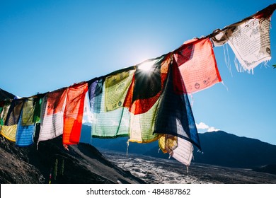 Colorful prayer flags with sun shining through one of prayer flags in Leh, Ladakh, India