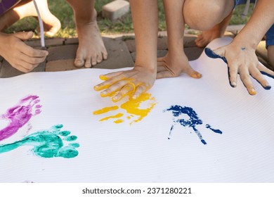 Colorful prints of children's feet and hands, painted in yellow and blue. creative patriotic concept. Ukrainian children are against war. Support Ukraine. Interesting childhood - Powered by Shutterstock