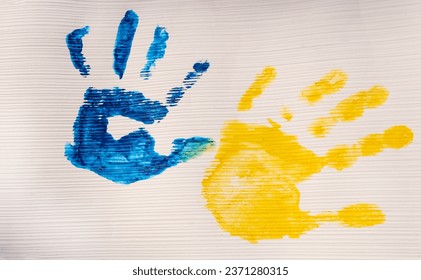 Colorful prints of yellow and blue painted children's hands. creative patriotic concept. Ukrainian children are against war. Support Ukraine - Powered by Shutterstock