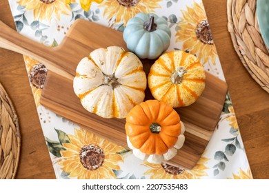 Colorful pumpkins on a stylish autumn dining table