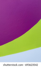 Colorful (purple, Lime Green And White) Painted Stone Wall As A Background / Texture. Vertical Format.