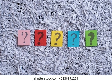 Colorful question mark symbol on paper against shredded paper background. Concept of FAQ, questions, mystery and recycle - Shutterstock ID 2139991233