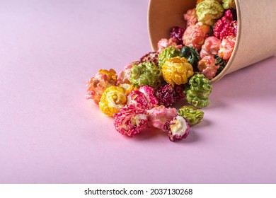 Colorful Rainbow Caramel Candy Popcorn On Pink Background. Cinema Snack Concept. Food For Watching Movie And Entertainment. Copy Space For Text, Close Up