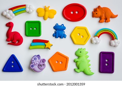 Colorful rainbow dinosaur front bug buttons on a white background
