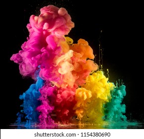 Colorful Rainbow Paint Drops From Above Mixing In Water. Ink Swirling Underwater.