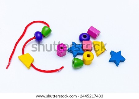 Colorful Rainbow Plastic Beads on White Background. Kid's DIY Craft. Children's Necklace Beads.