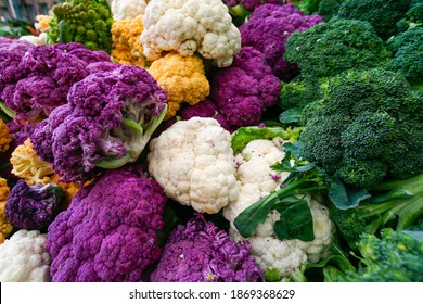 Colorful raw broccoli and purple and white cauliflower