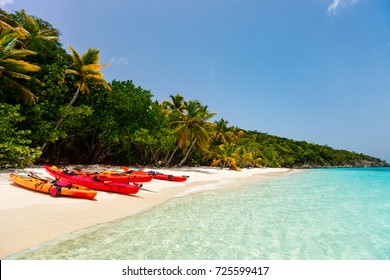 Colorful Red Kayaks At Tropical White Sand Beach In Caribbean