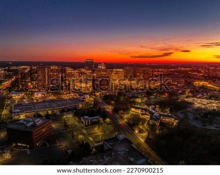 Colorful red, orange, yellow sunset sky over Reston town business center in Virginia