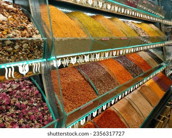 Colorful red yellow orange green brown spices and rose tea in plastic boxes from Istanbul Egyptian Bazaar and Grand Bazaar