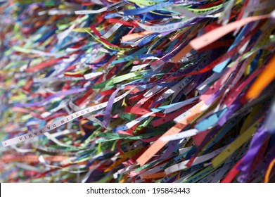 Colorful religious Brazilian wish ribbons Fita do Bonfim tied on church fence in Salvador Bahia Brazil