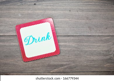 A Colorful Retro Drink Coaster On A Wooden Surface