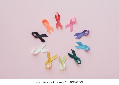 colorful ribbons on pink background, cancer awareness, World cancer day, National cancer survivor day, world autism awareness day - Shutterstock ID 1559259092