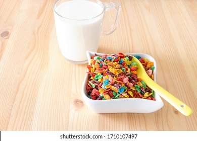 Colorful Rice Cereal With Milk For Kids. Kids Healthy Quick Funny Breakfast. Wooden Background. Copy Space.