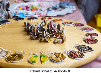 Colorful rings and earrings for sale to tourists at the market, close-up. Vintage old-fashioned earrings and rings at the bazaar. Retro style jewelry: rings and earrings with precious stones - Shutterstock ID 2365206745