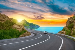 Colorful Road Landscape At Sunset In Beautiful Nature Scenery. Travel Landscape For Summer Vacation On Highway On The Beach. Car Driving On Nature Road By The Sea. Highway Landscape In Summer Holiday