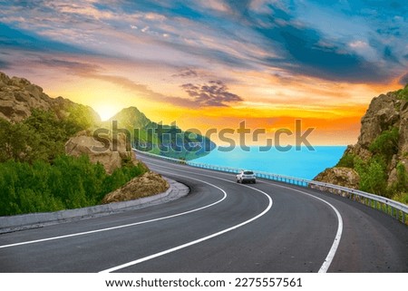 colorful road landscape at sunset in beautiful nature scenery. Travel landscape for summer vacation on highway on the beach. car driving on nature road by the sea. highway landscape in summer holiday