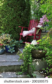 Colorful rocking chair in a cottage garden setting. 