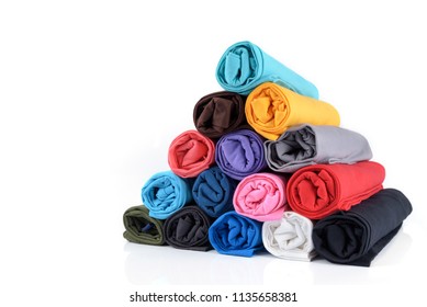 Colorful of rolls cotton T shirt made to Pyramid shape isolated on white background. - Shutterstock ID 1135658381