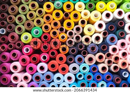 Colorful rolls of sewing thread in a box