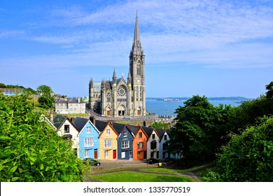Colorful row houses with towering cathedral in background in the port town of Cobh, County Cork, Ireland - Shutterstock ID 1335770519