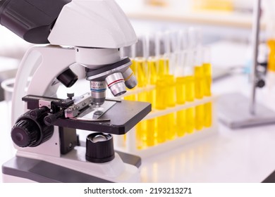 Colorful Rows Of Laboratory Test Tubes And Microscope With Metal Lens, Science Background. Test Tube Row. Concept Of Medical Or Science Laboratory, Close Up, Macro Photography Picture.