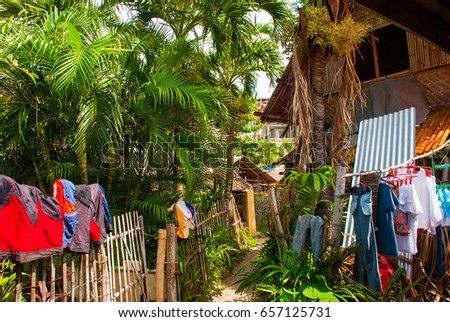 Colorful rural house with many dried clothes Apo island, Philippines