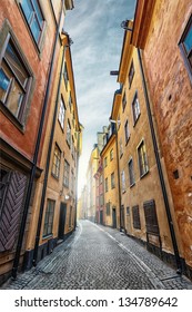 Colorful rustic Alley with Cobblestone road with a surrealistic feeling, Prastgatan, Stockholm - Sweden