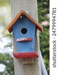 Colorful rustic wooden birdhouses in bright colors