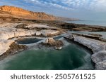 Colorful salt pools formed by erosion and evaporation on the shoreline of Israel