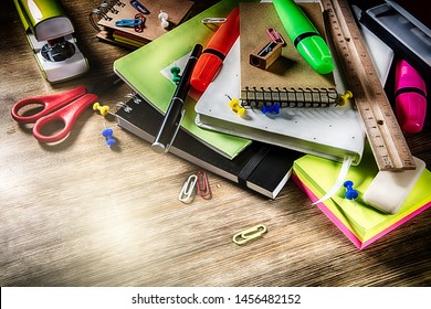 Colorful school supplies over wooden desktop. Back to school concept