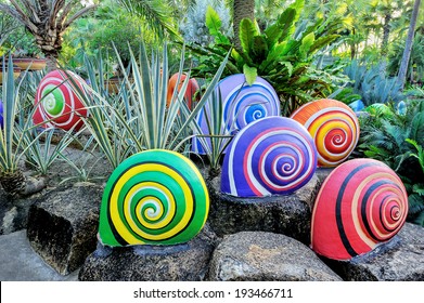 Colorful Of Sculpture Snails In Beautiful Garden.