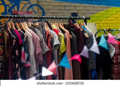 Colorful Secondhand Clothes On Hangers At Local Market On The Street