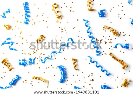 Colorful serpentine streamers and confetti on white background, top view