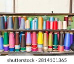 Colorful Sewing Thread Spools on Wooden Shelves