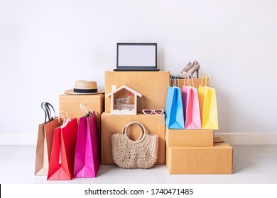 Colorful shopping bag with stack of cardboard boxes and fashion items at home, Website online shopping concept with copy space - Shutterstock ID 1740471485