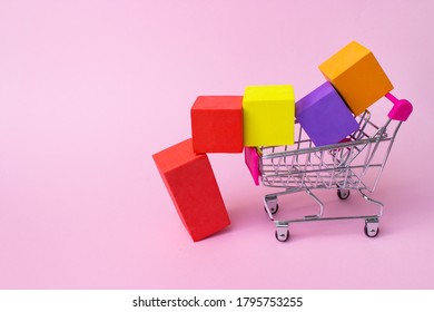 Colorful shopping cart with red plastic handle and multicolor boxes inside on pink background. Mock up header leave space for adding text or design for promote business campaign on line - Powered by Shutterstock