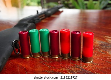 Colorful Shotgun Bullets On The Blurred Background Of The Gun. Soft And Selective Focus.                 