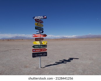 A Colorful Signpost Showing The Ways To Different Cities