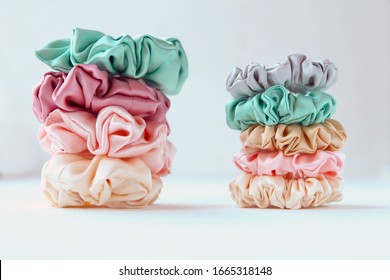 Lot of Colorful silk Scrunchies on white. Luxury Hairdressing tools and accessories. Hair Scrunchies, Elastic HairBands, Bobble Sports Scrunchie Hairband