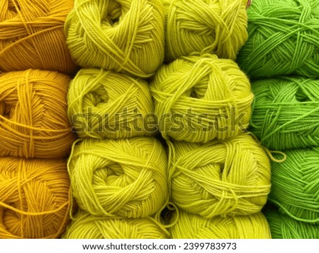Colorful skeins of yarn for knitting as background, top view
