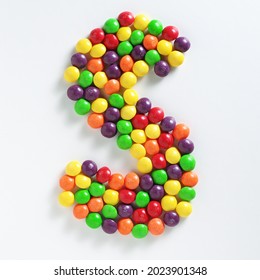 Colorful skittles candies in S-shape on white background, top view