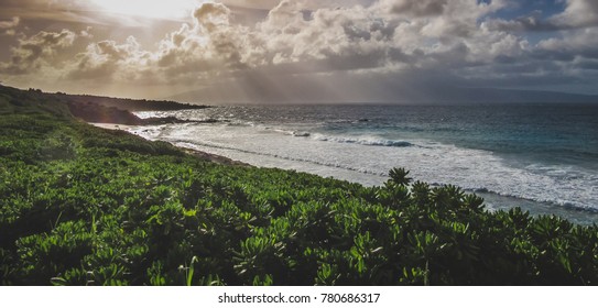 Colorful sky with clouds over secluded Oneloa Beach, Maui, Hawaii