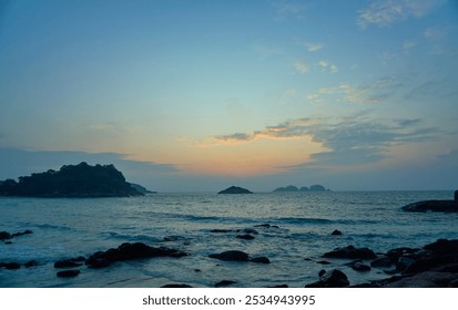 Colorful sky is providing a beautiful backdrop to the rocky coast and islands - Powered by Shutterstock