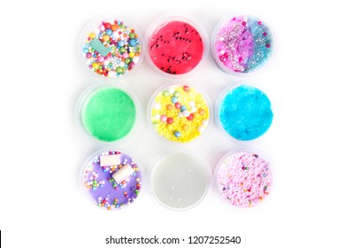 Colorful Slimes Inside Plastic Boxes. Kids Gunk Toy Isolated Over White Background. 