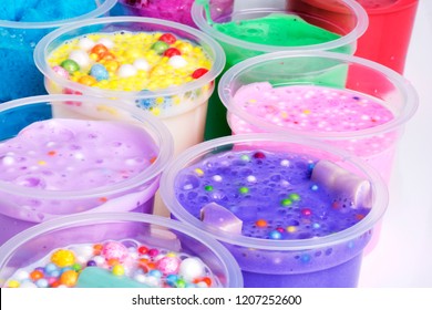 Colorful Slimes Inside Plastic Boxes. Set Of Kids Gunk Toy, Close Up View.  