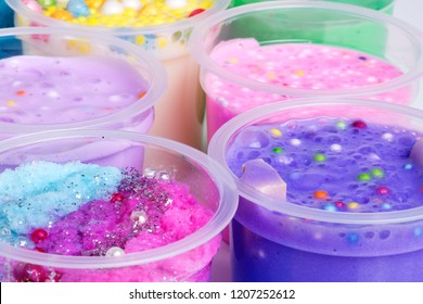 Colorful Slimes Inside Plastic Boxes. Set Of Kids Gunk Toy, Close Up View.  