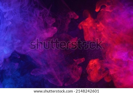 Colorful smoke clouds and shiny glitter particles flowing cosmic abstract background