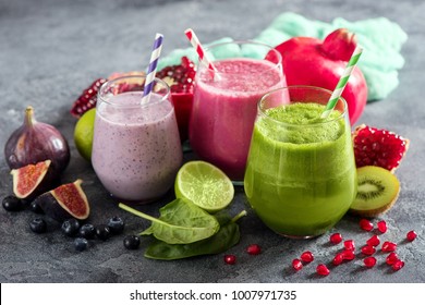 Colorful smoothie, healthy detox vitamin diet or vegan food concept, fresh vitamins, breakfast drink with spinach, pomegranate, figs and blueberries - Shutterstock ID 1007971735